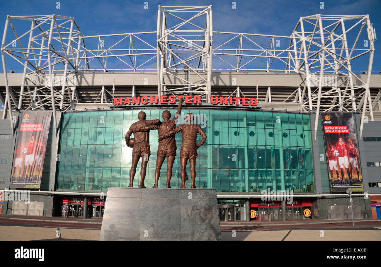 The statue to Sir Bobby Charlton, George Best Denis Law at the main entrance (East stand) to Old Trafford, Manchester. Stock Photo