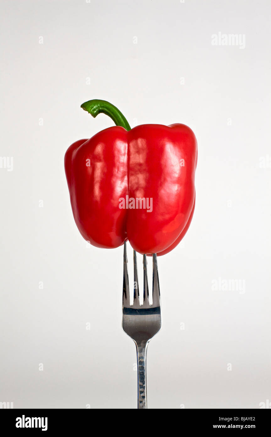 Food on your fork, a red bell pepper. on a fork on a white background. Stock Photo