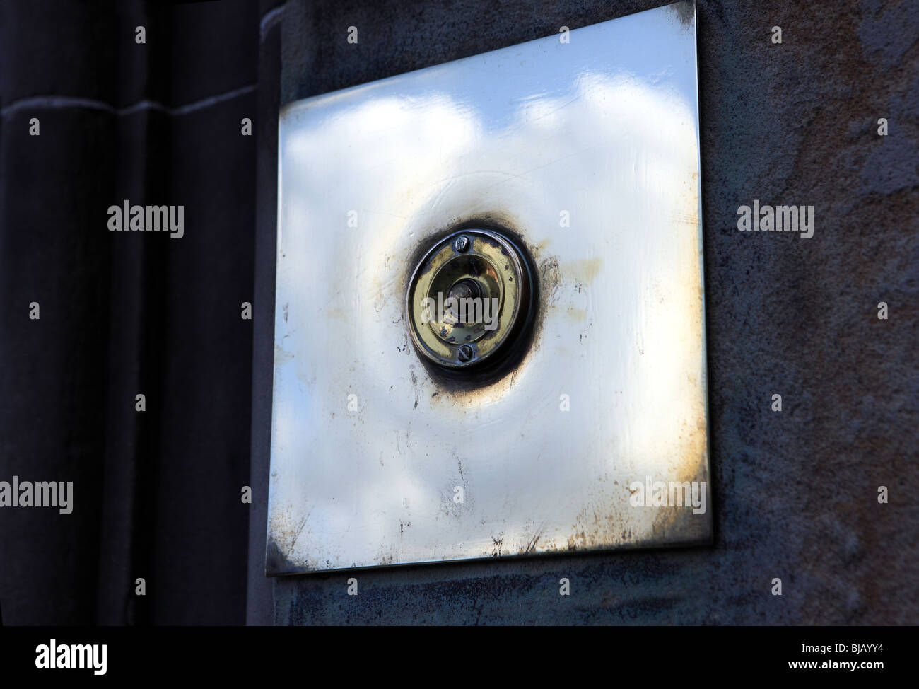 Brass door bell on a sandstone building Stock Photo