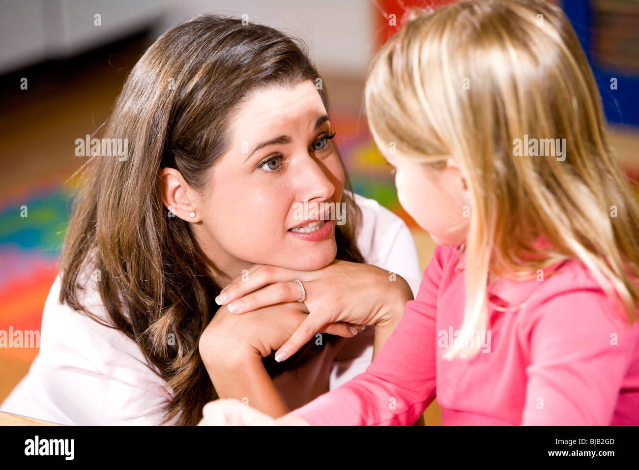 Teacher talking to preschool child Stock Photo Alamy
