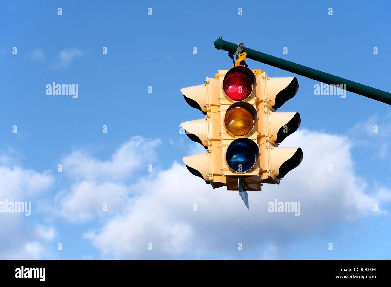 Traffic light, with blue sky background, suspended on an arm.  Photo by Darrell Young. Stock Photo