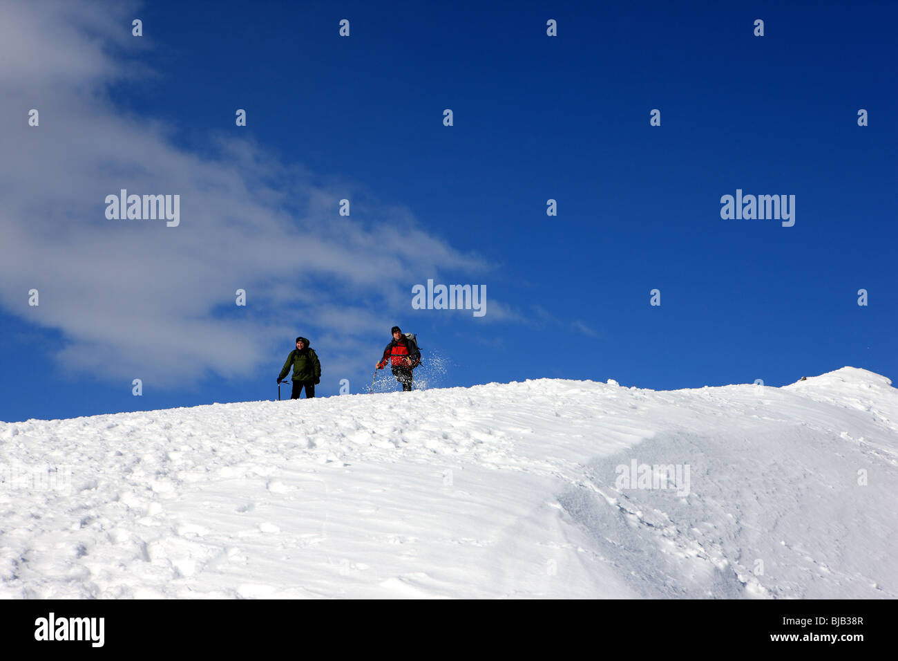 Two hill walkers descending from the summit of Meall nan Tarmachan Stock Photo