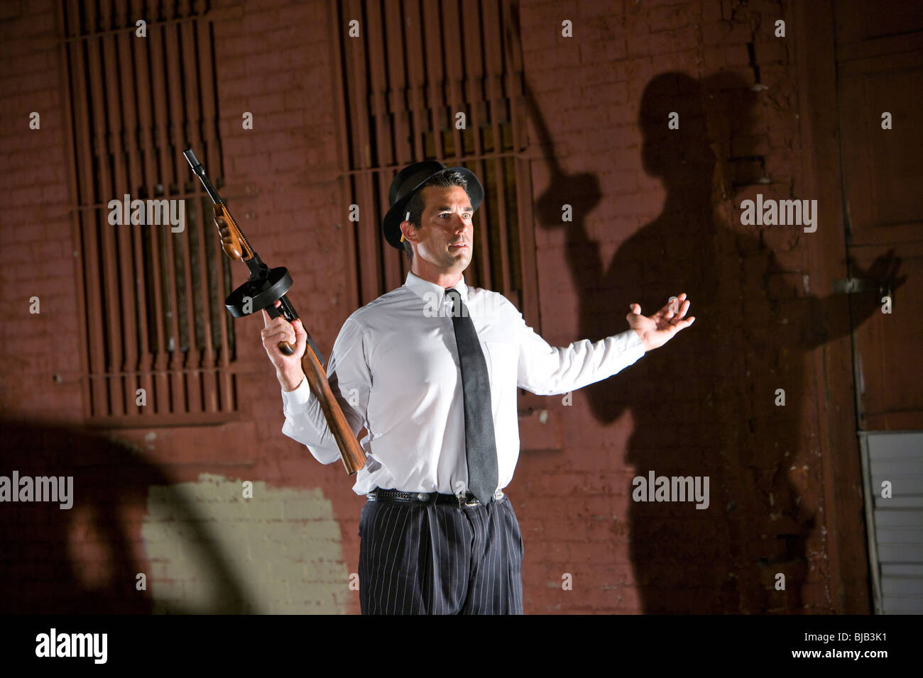 Gangster Holding Tommy Gun With Hands In Air Stock Photo Alamy