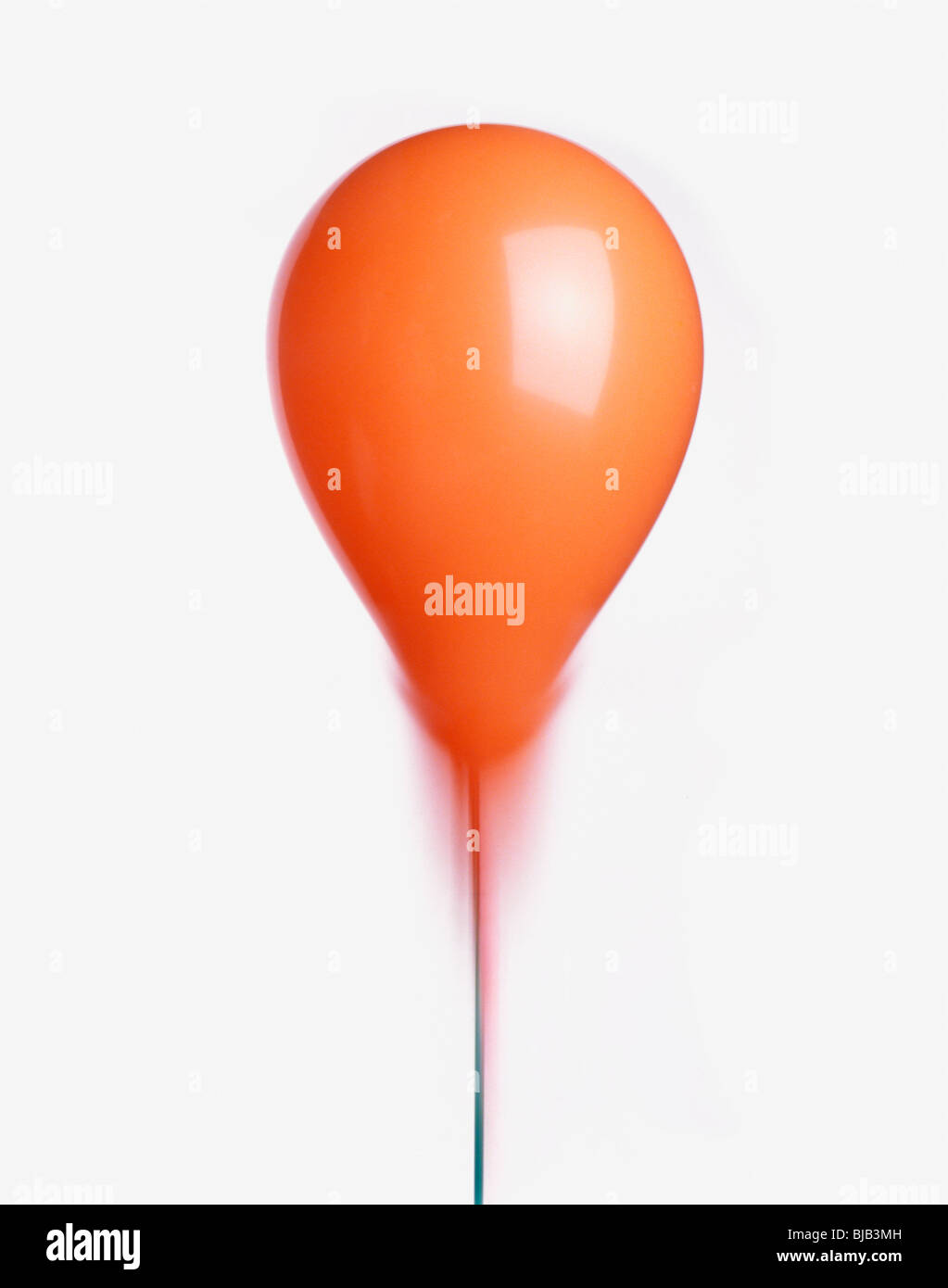orange balloon with ribbon cut-out on white background Stock Photo