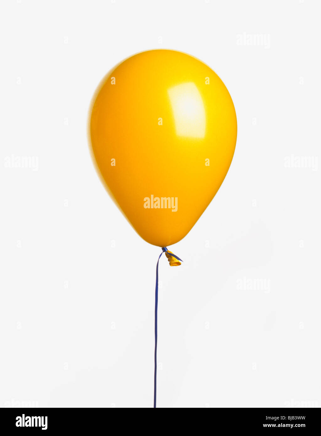 yellow balloon with ribbon on white background Stock Photo