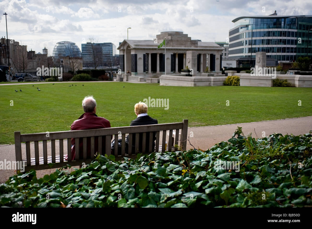 Two people sitting on a bench in Trinity Square Gardens in London.  Photo by Gordon Scammell Stock Photo