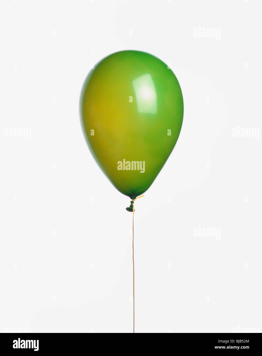 green balloon with ribbon cutout on white background Stock Photo