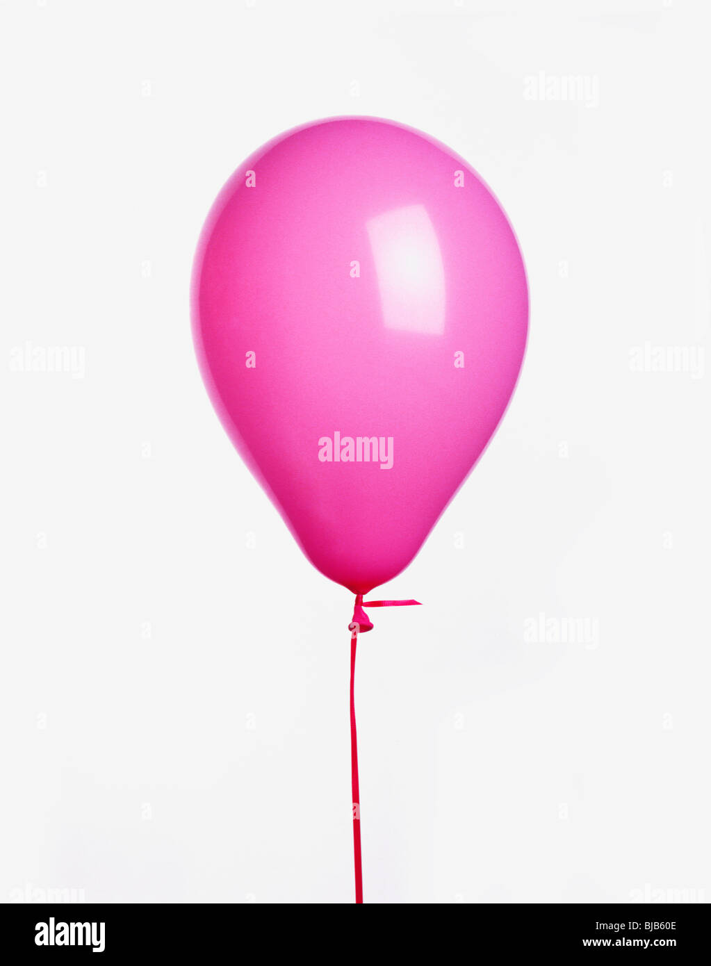 pink balloon with ribbon cut-out on white background Stock Photo