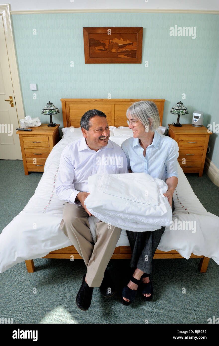 Couple changing sheets on a bed hires stock photography and images Alamy