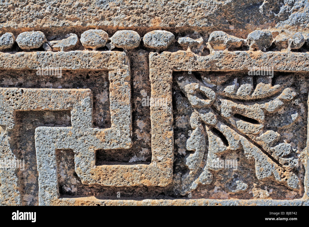 Stone relief with solar swastika, Roman temple of Helios, Qanawat, Syria Stock Photo