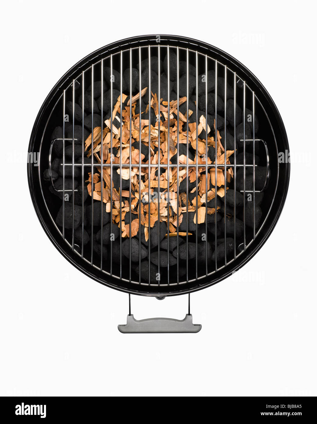 barbecue grill with wood chips and charcoal cut out on white background Stock Photo