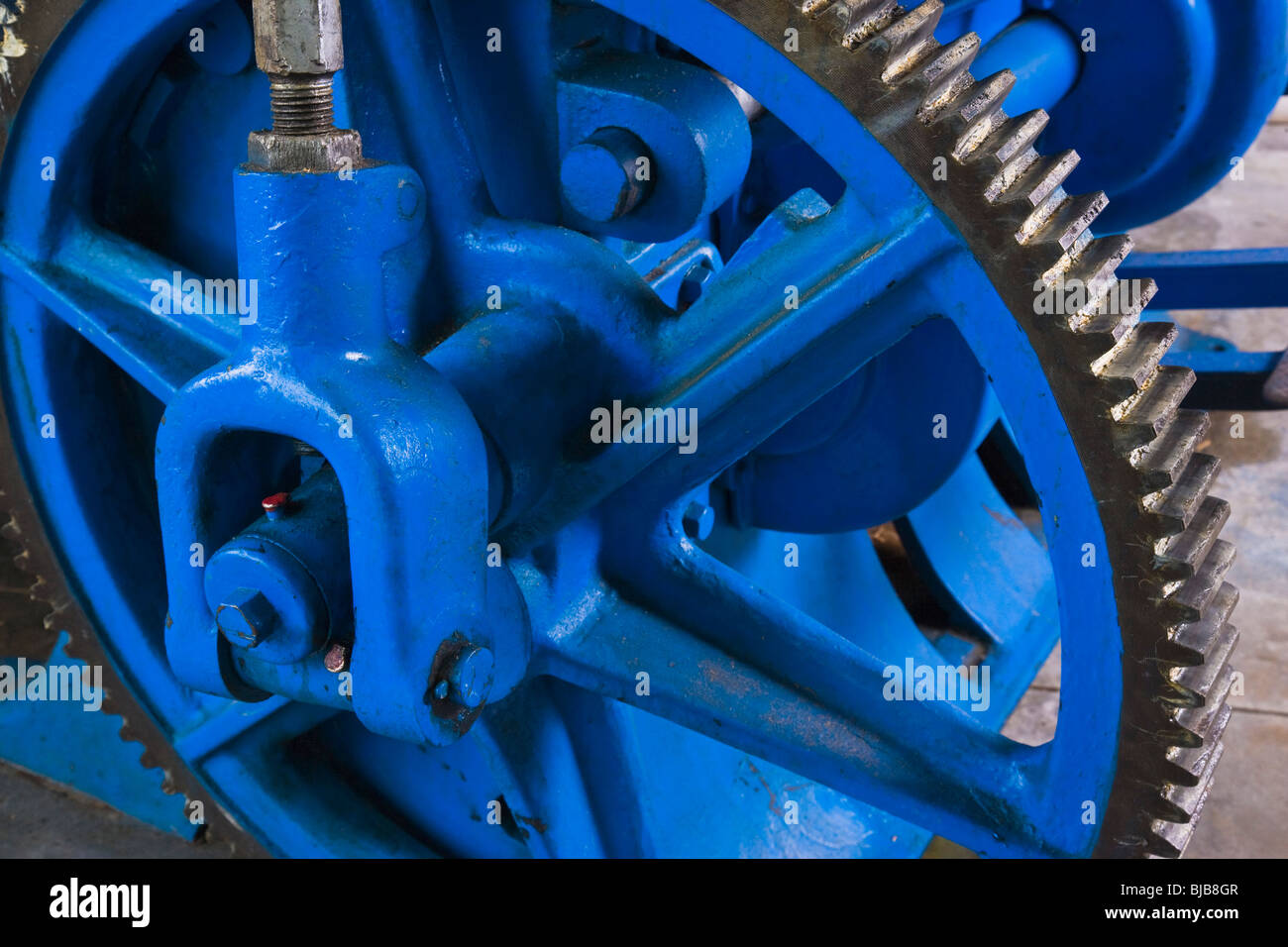 Gear wheel from old die cutting machine at print shop. Stock Photo