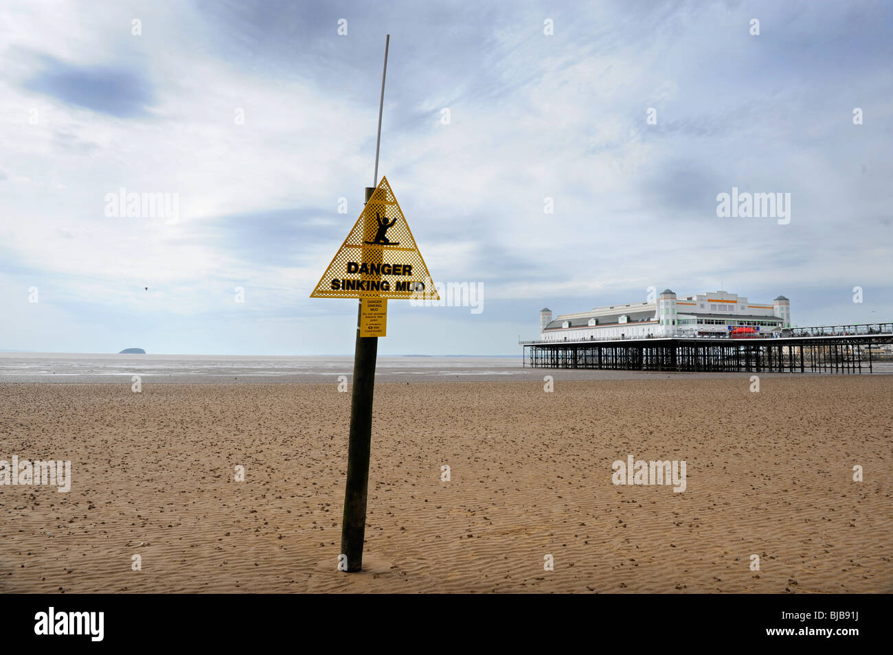 General view of the beach at Weston-Super-Mare with Grand pier and mud warning sign UK Stock Photo