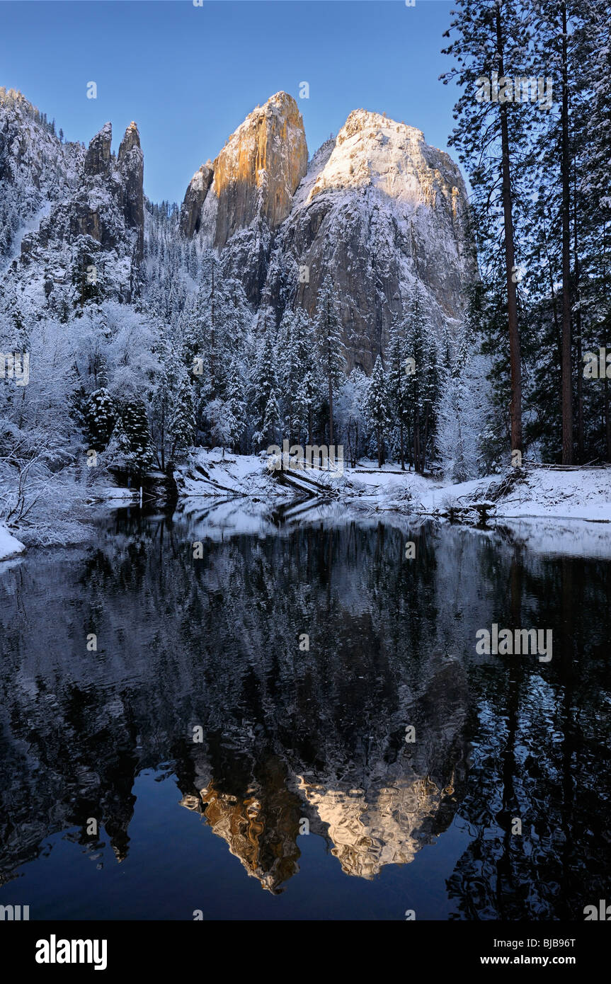 Cathedral Rocks and Spires reflected in the Merced River after a snowfall in winter Yosemite National Park California USA Stock Photo