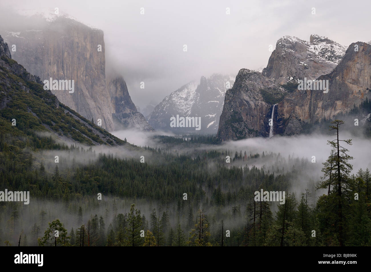 Clouds and fog in Yosemite Valley with Bridalveil Fall after a winter rain storm seen from Tunnel View Yosemite National Park California USA Stock Photo