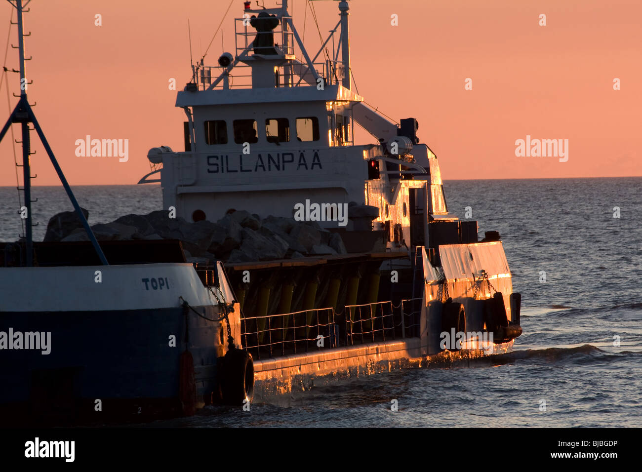sea defence construction boat , Tywyn Stock Photo - Alamy