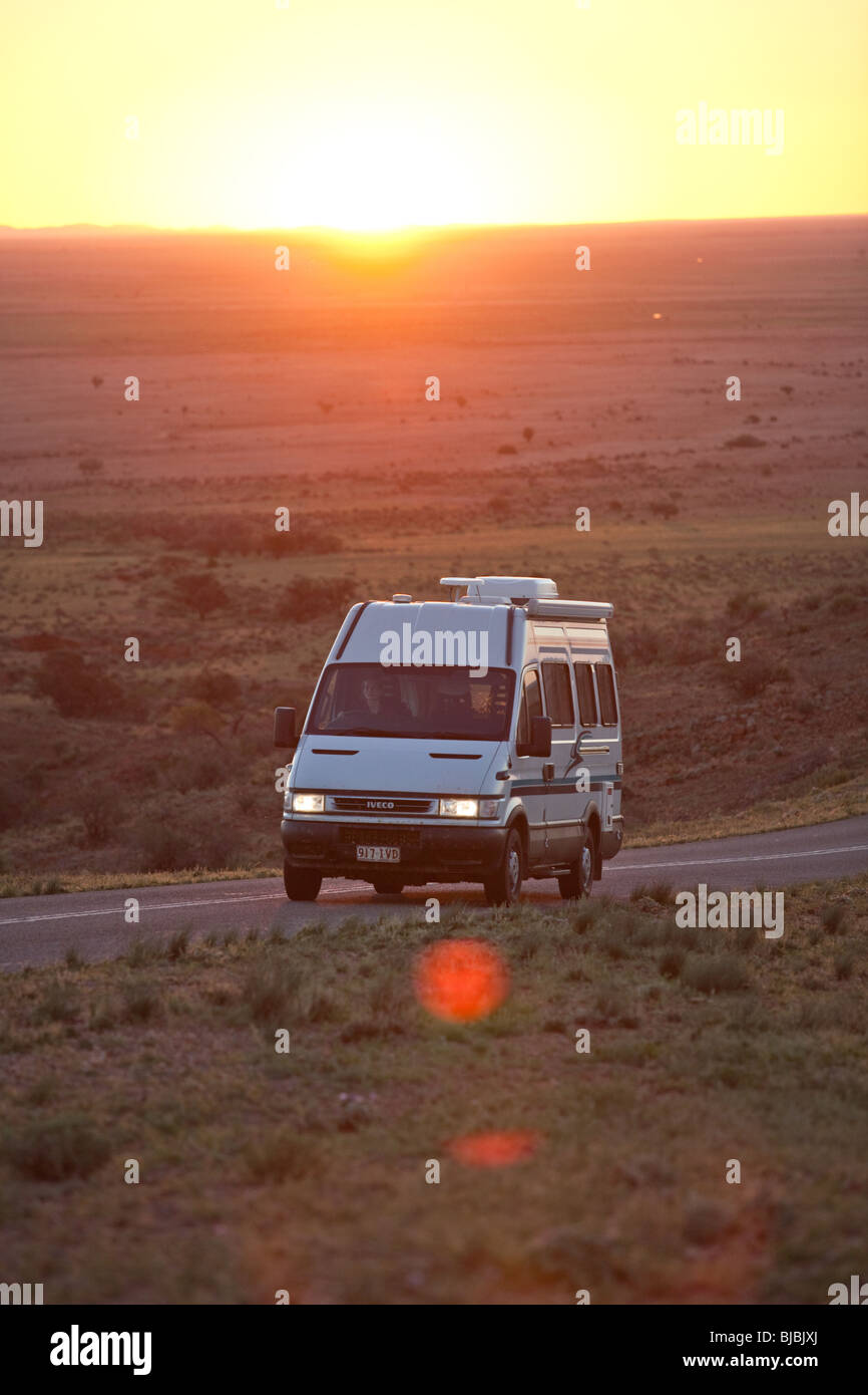 A camper van driving through Australian outback, Silverton NSW, Australia Stock Photo