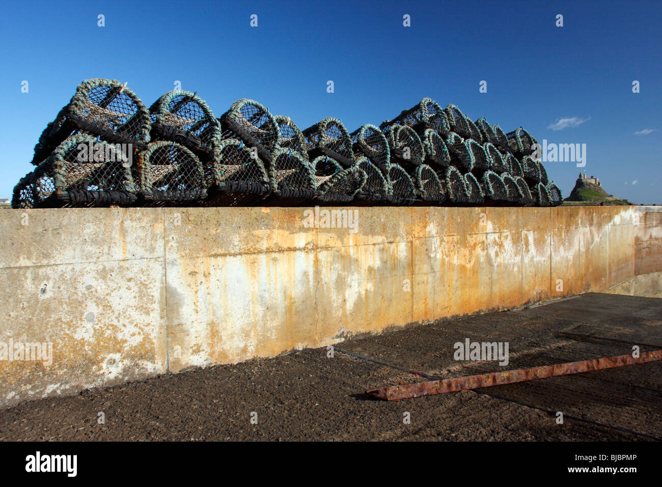 Lobster Pots, on harbour wall, Holy Island, Northumberland, England, UK Stock Photo