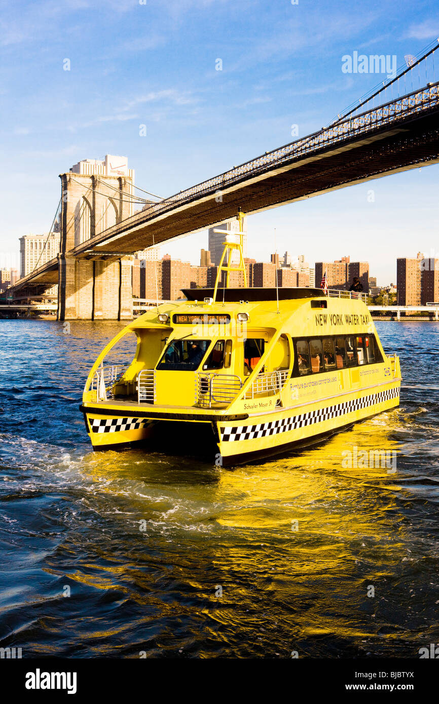 ferry under Brooklyn Bridge, Manhattan, New York City, USA Stock Photo