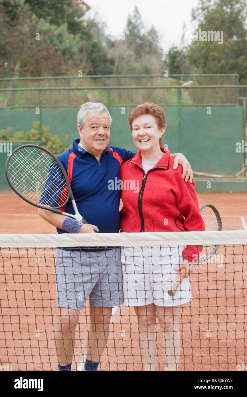 Senior Hispanic couple playing tennis Stock Photo - Alamy