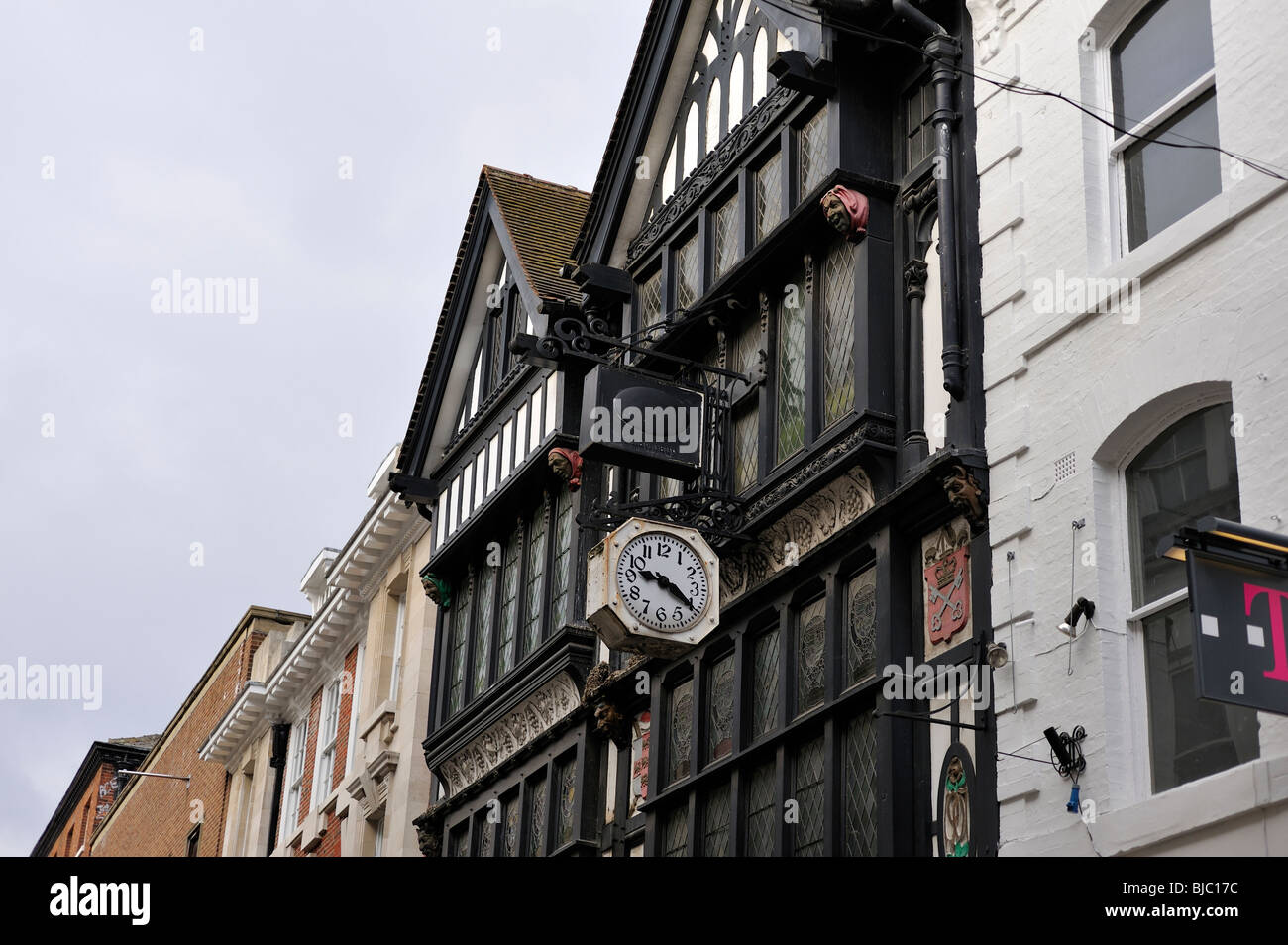 Very old black and white building with clock and Gargoyles York North Yorkshire UK Stock Photo