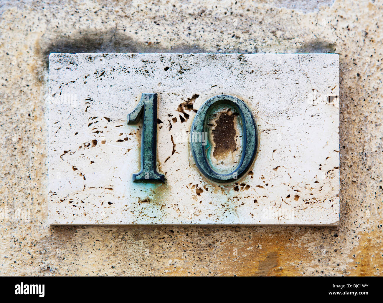 Block number on a weathered wall Stock Photo