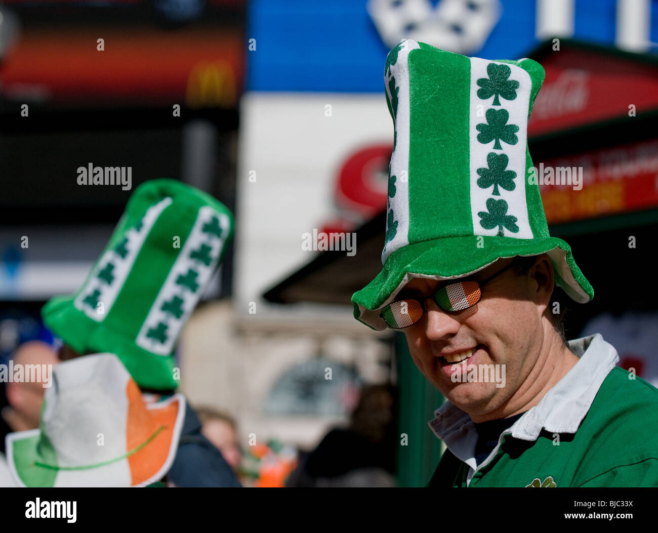 A man wearing a novelty hat and spectacles during the St Patricks Day Parade in London Stock Photo