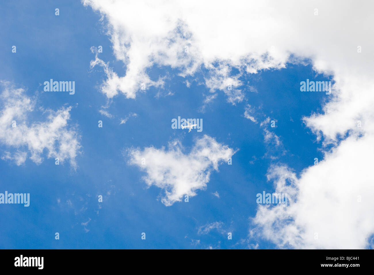 Commercial airplane flying through cloudscape Stock Photo