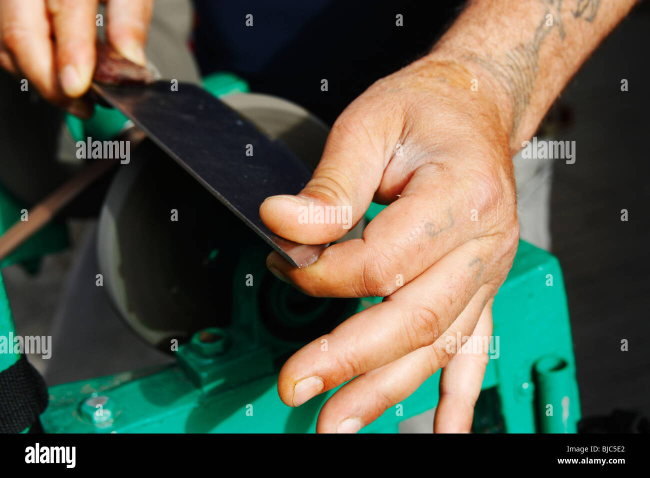 Man sharpening knife in street in Spain Stock Photo Alamy