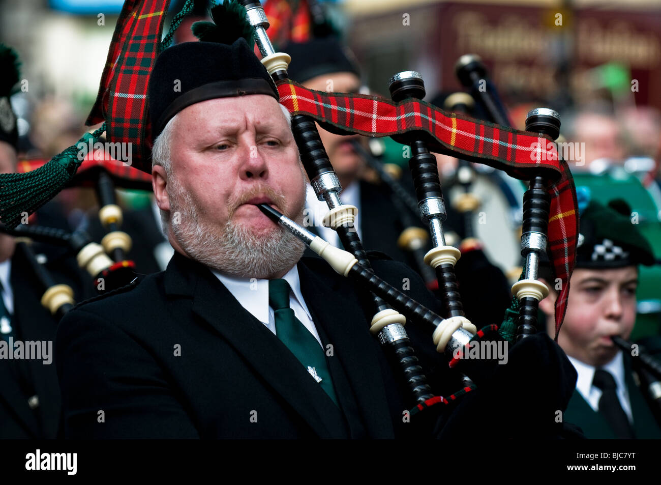 A piper playing the bagpipes during the St Patricks Day Parade in London. Stock Photo