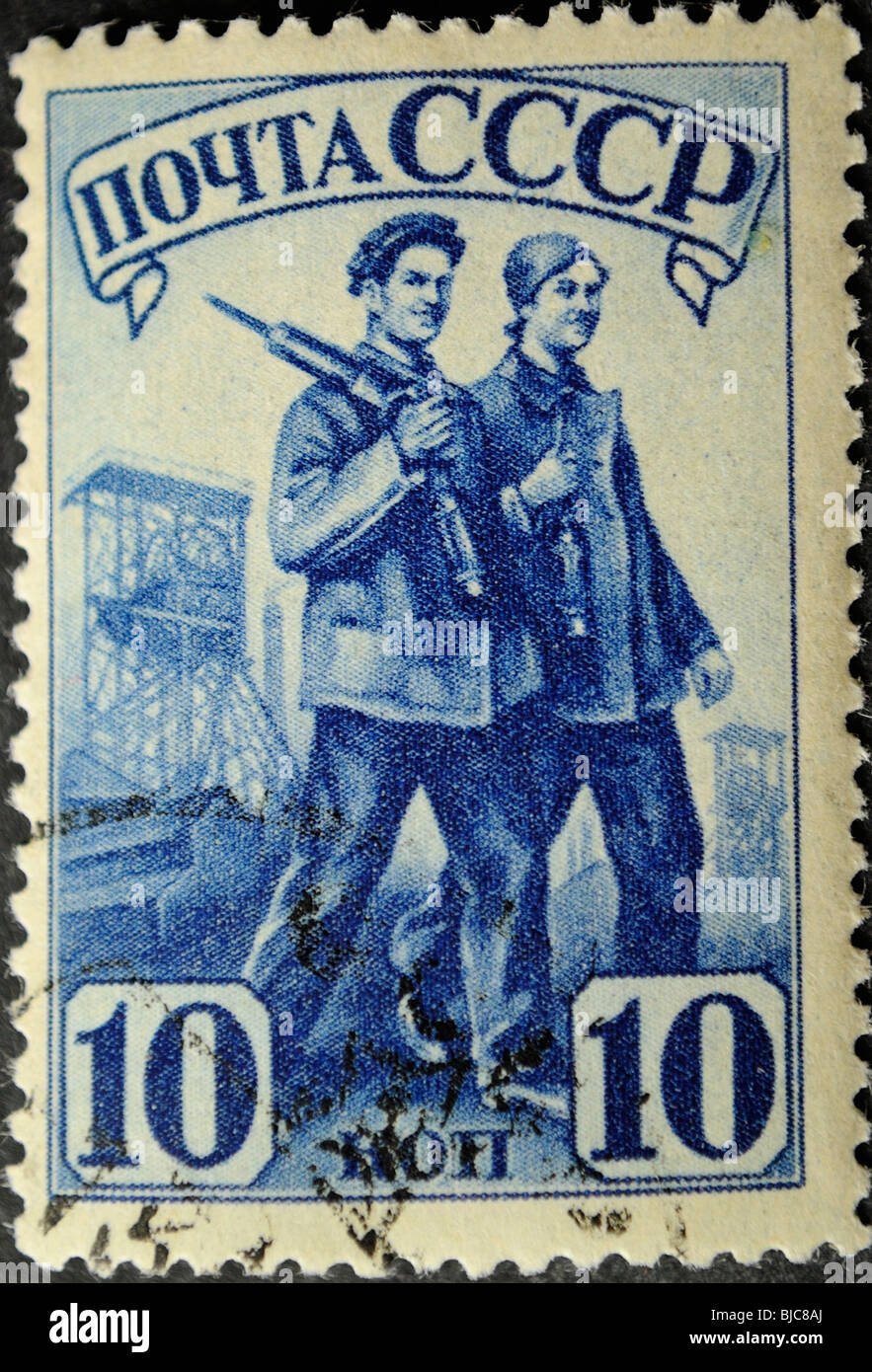 USSR - CIRCA 1941: A Stamp printed in the USSR shows the worker and the working woman, circa 1941 Stock Photo