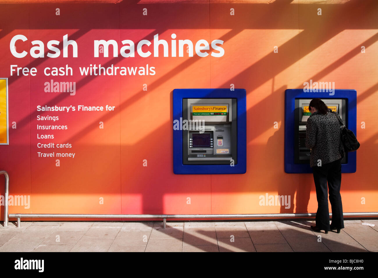 A pair of hole in the wall cash machines outside Sainsbury's store, Braehead, Renfrewshire, Scotland. Stock Photo