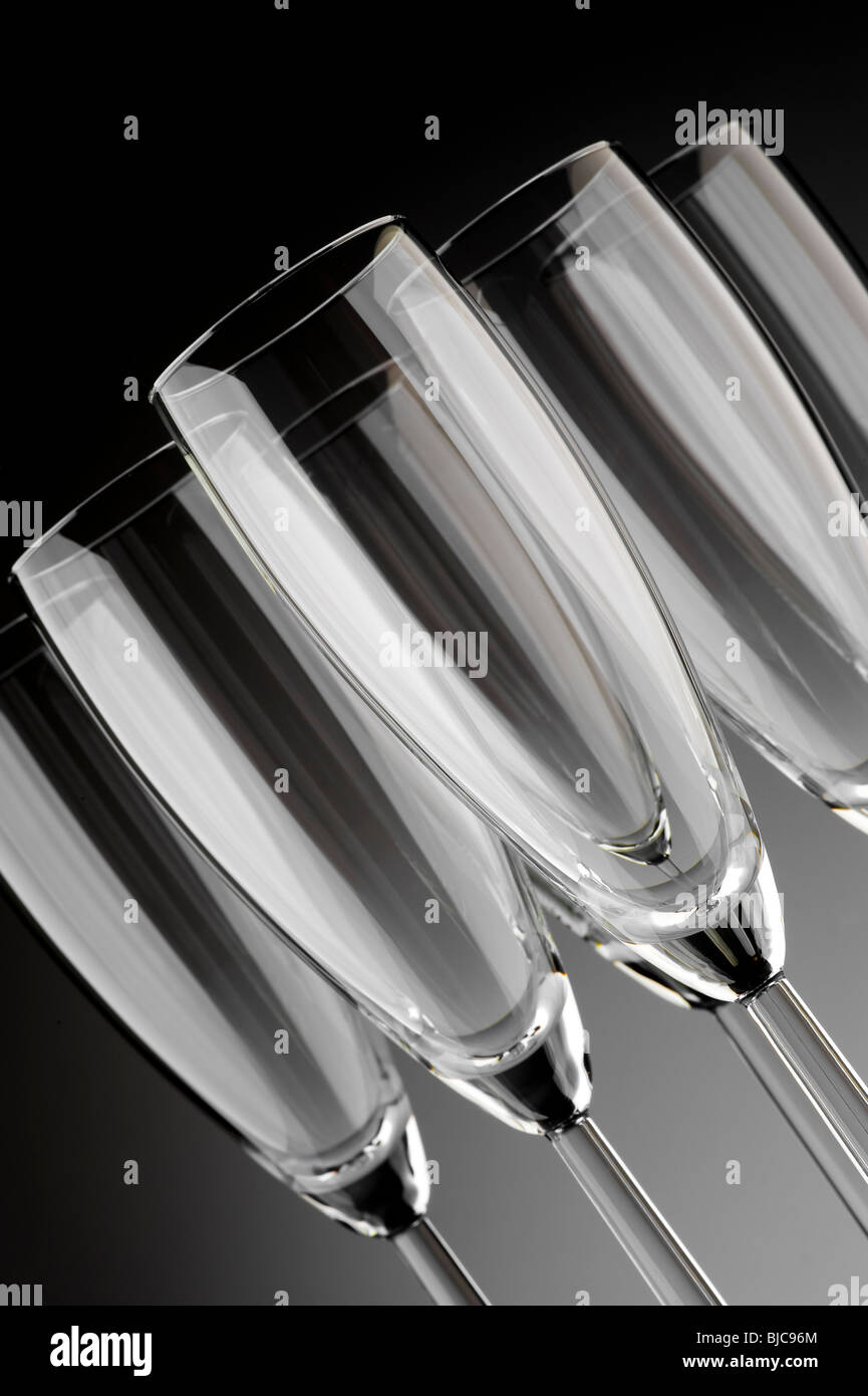 Studio shot of angled empty champagne flute glasses on a graduated