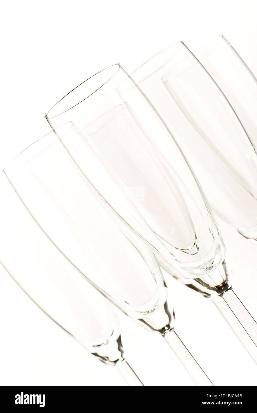 Studio shot of angled empty flute glasses on white background Stock