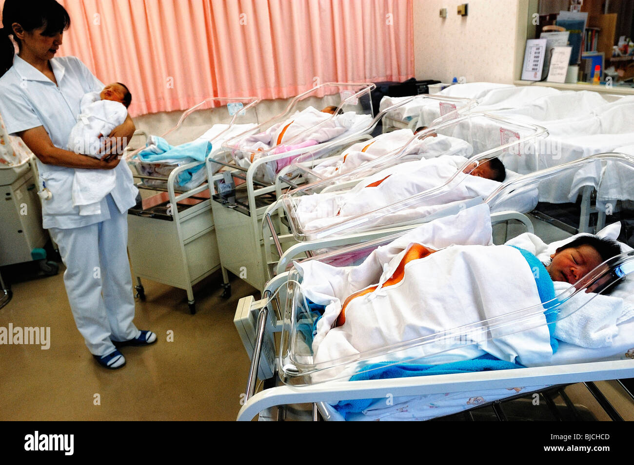 Newly born babies sleep in the maternity ward of a hospital in Tokyo