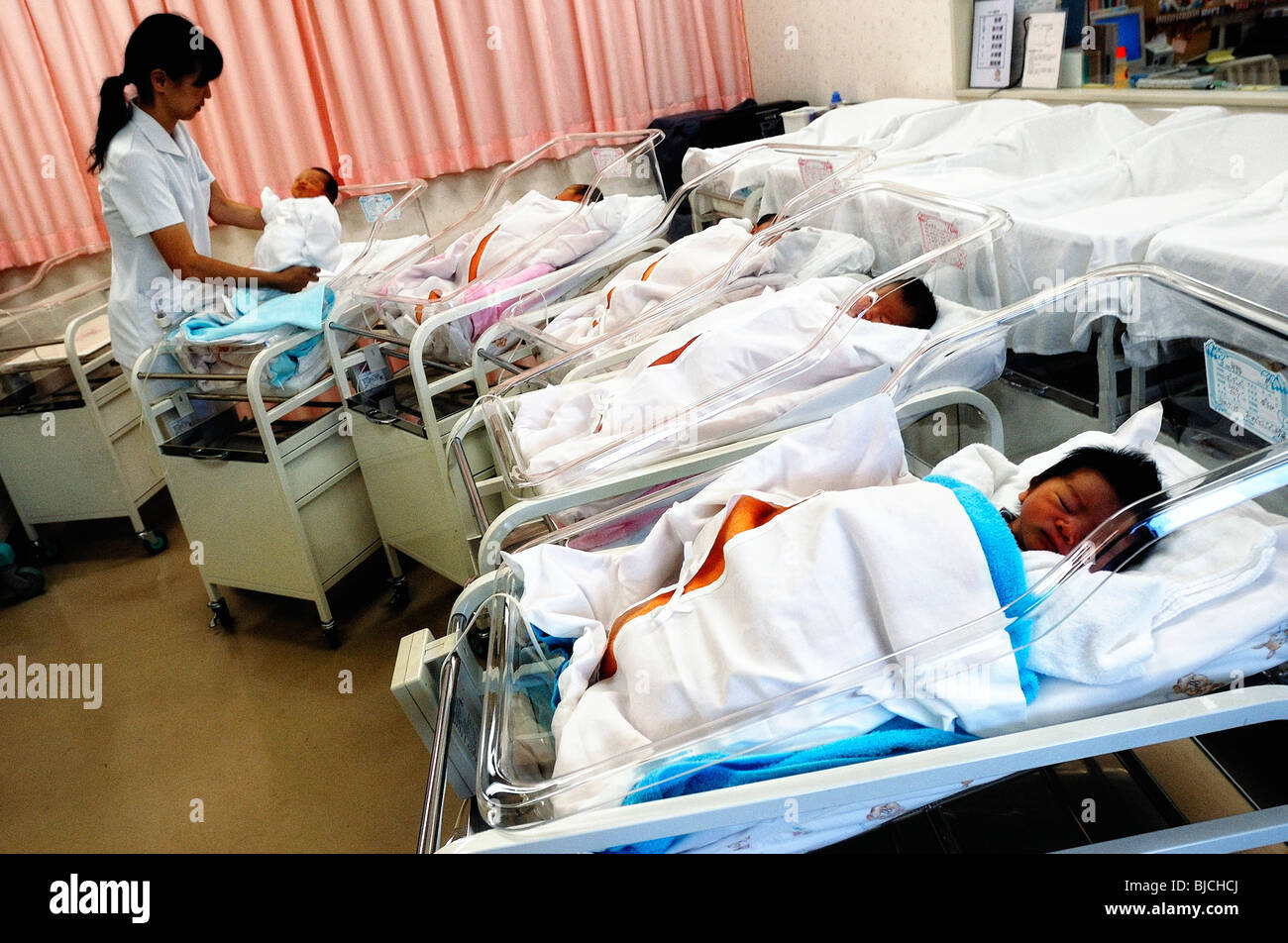 Newly born babies sleep in the maternity ward of a hospital in Tokyo