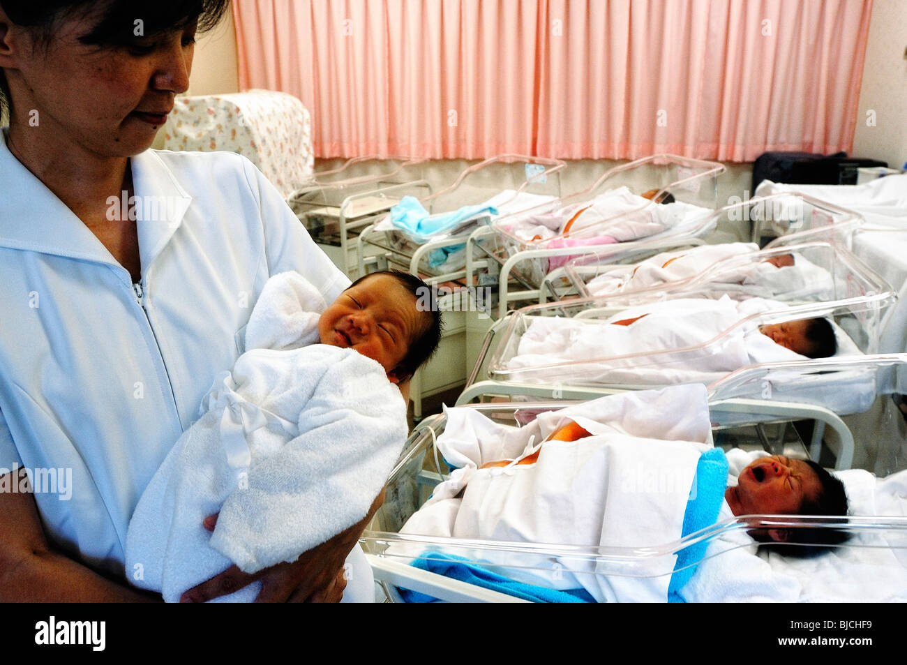 Newly born babies sleep in the maternity ward of a hospital in Tokyo