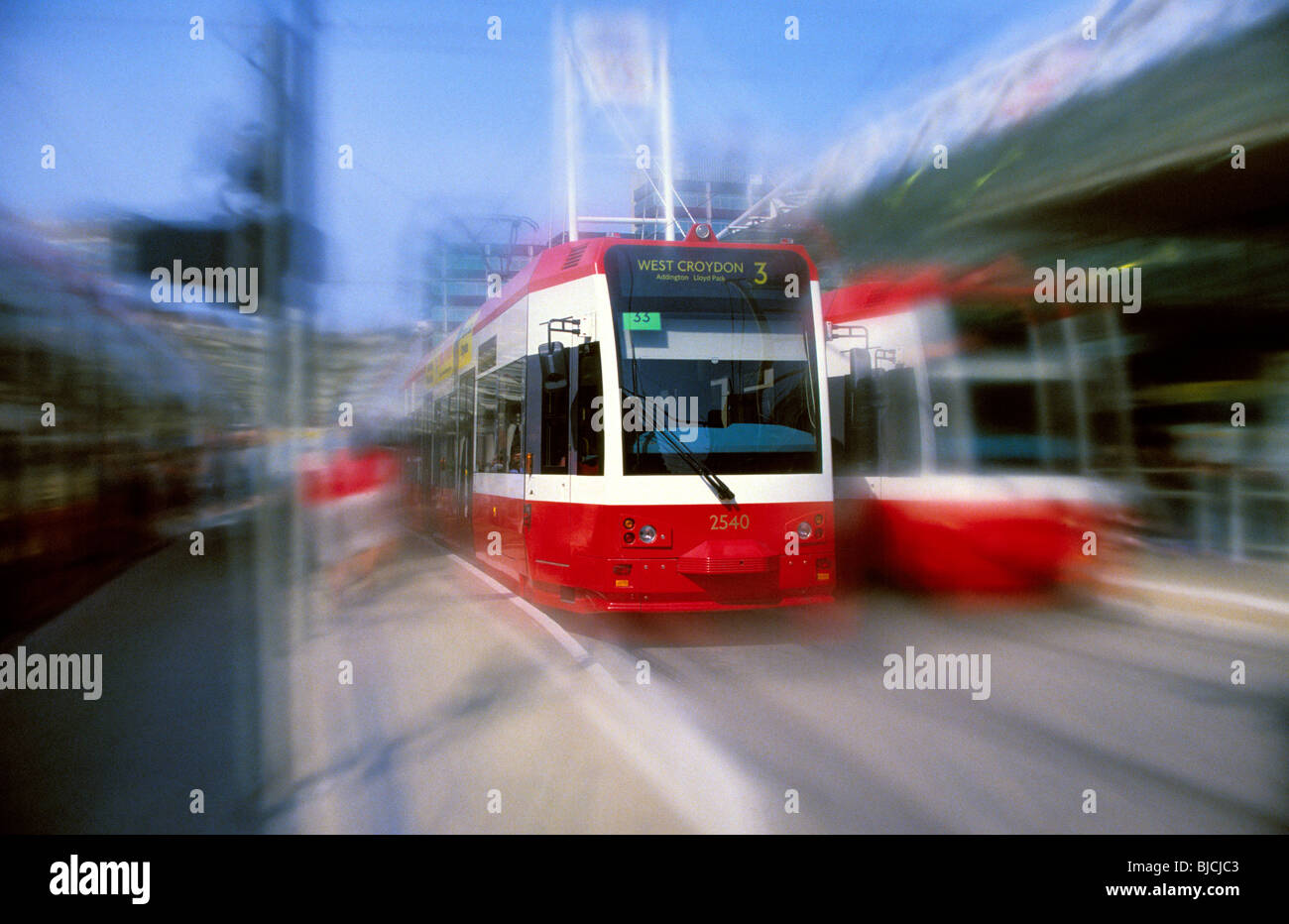 Trams in original Tramlink livery at East Croydon station (with speed effect) Stock Photo