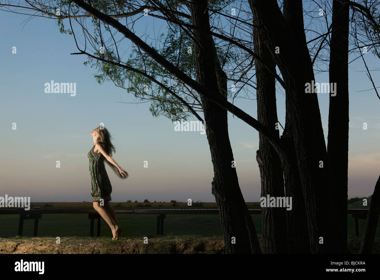 Woman on tiptoes, arms out, jumping Stock Photo Alamy