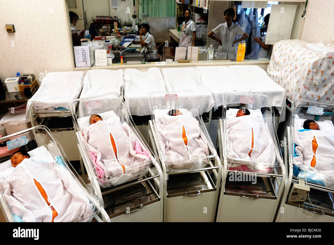 Newly born babies sleep in the maternity ward of a hospital in Tokyo