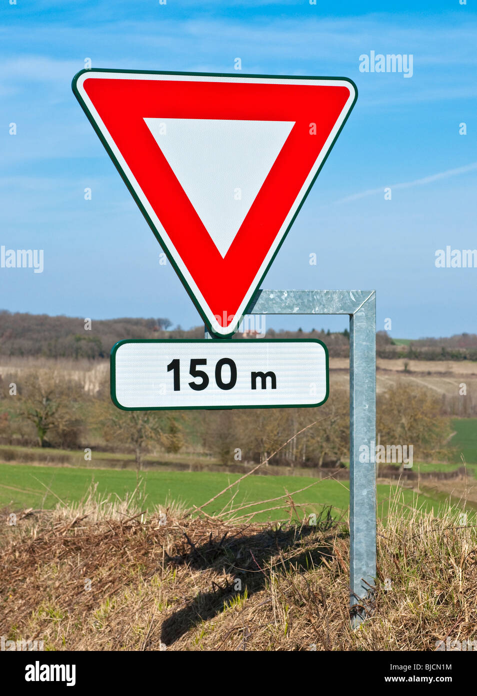 Modern road traffic sign indicating junction 150 meters ahead - Indre ...