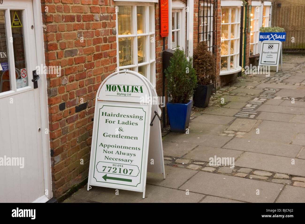 A traditional row of small shops in a shopping parade within Chesham town centre Buckinghamshire UK Stock Photo