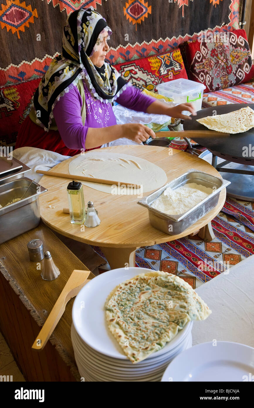 Woman making Gozleme, thin bread filled with potato, spinach, cheese or minced meat, Istanbul, Turkey Stock Photo