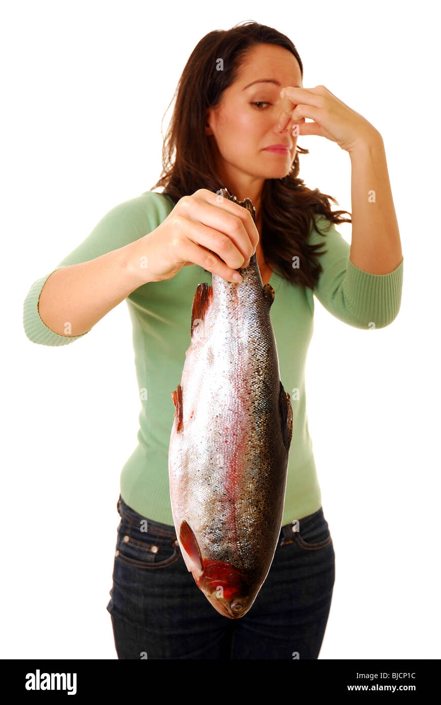 Woman holding a smelly fish Stock Photo