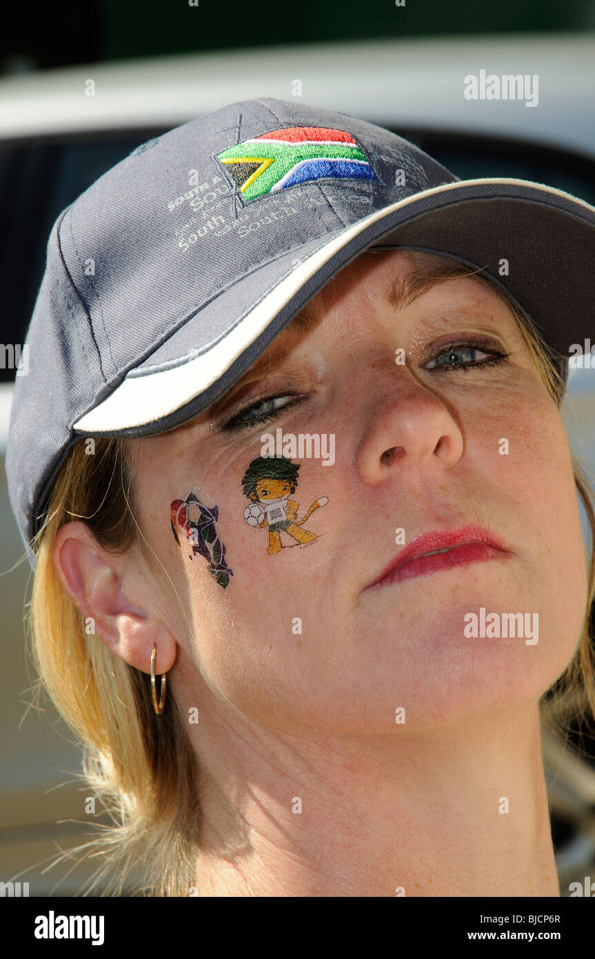 Portrait of a woman wearing a South African cap and wearing World Cup 2010 tattoos on her face Stock Photo