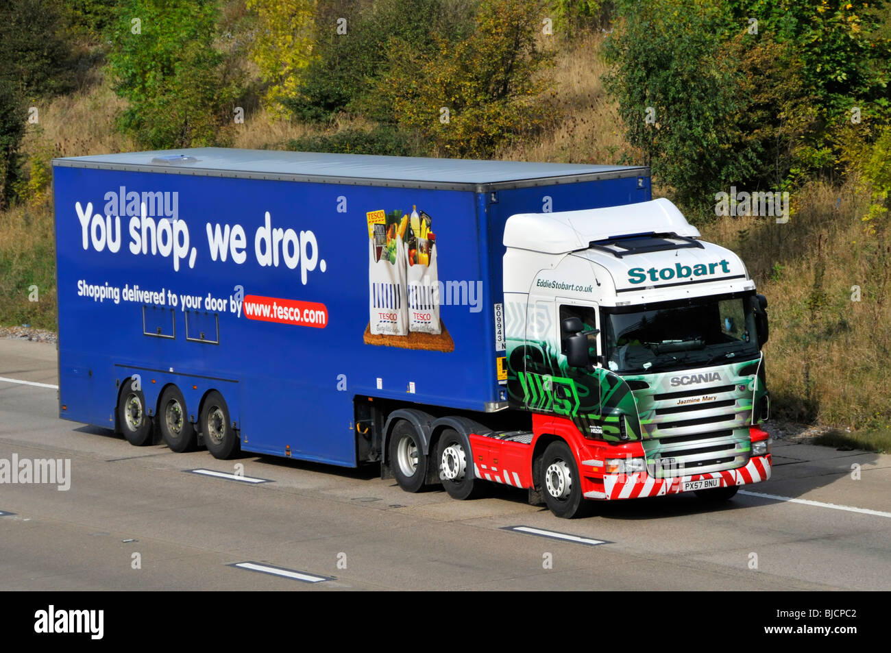 M25 motorway Tesco trailer behind a Eddie Stobart lorry truck Stock Photo