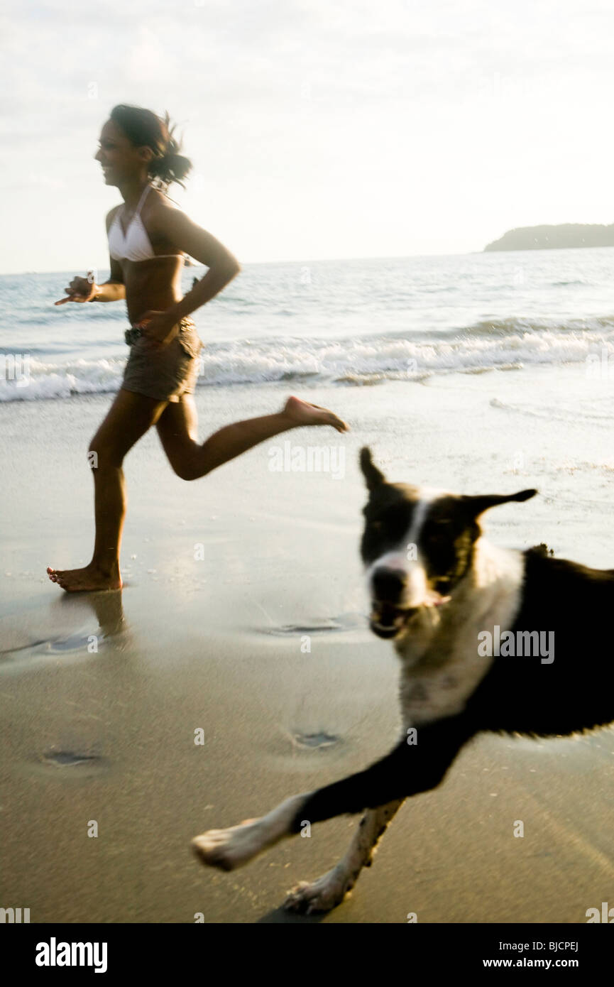 Woman running with dog. Stock Photo