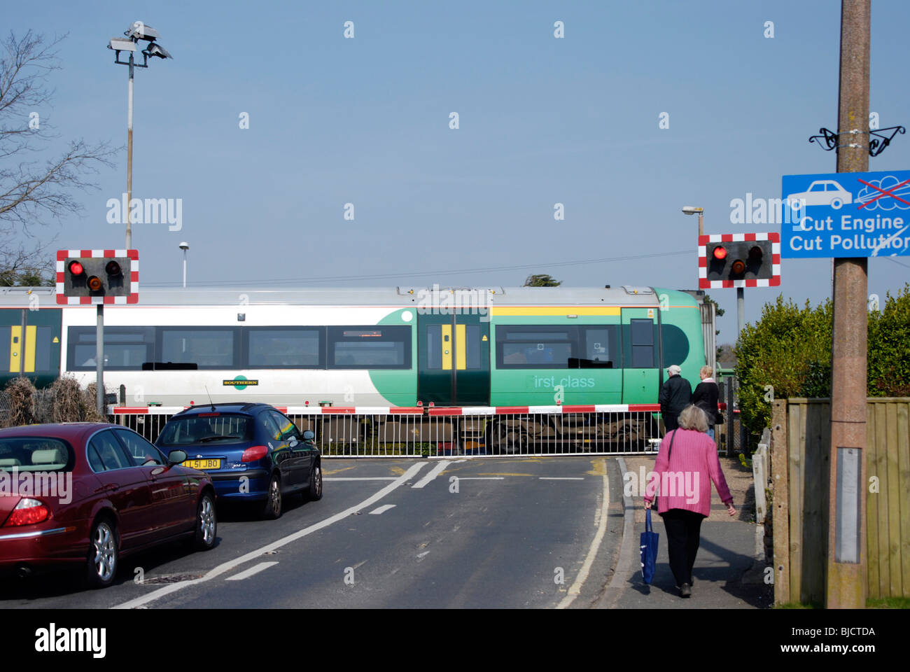traffic building up with railway level crossing barriers down with a ...