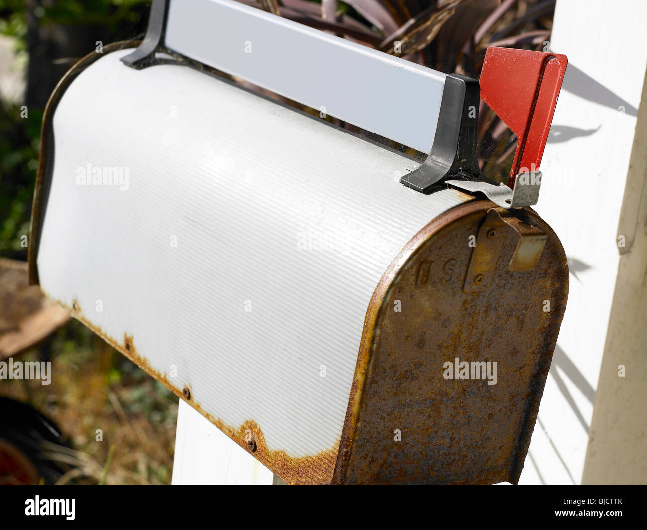 an American style post box outside a house, with the red flag up Stock