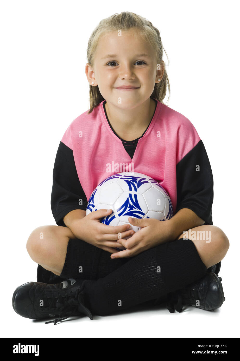 Young girl in a soccer uniform with ball Stock Photo Alamy